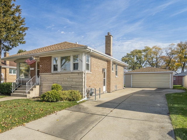 bungalow-style house with a garage, an outbuilding, and a front yard