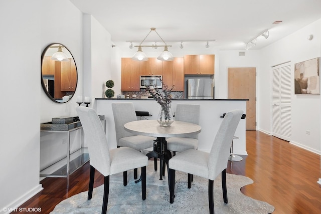 dining room with dark hardwood / wood-style floors