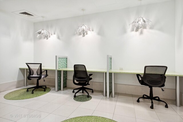 exercise room featuring light tile patterned flooring