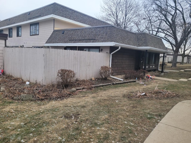 view of property exterior featuring a lawn