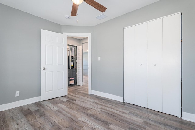 unfurnished bedroom with ceiling fan, light hardwood / wood-style floors, and a closet