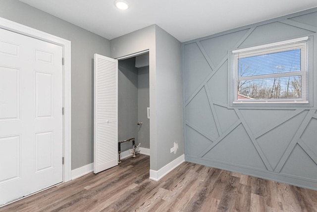 bedroom with wood-type flooring and a closet