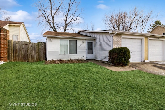 view of front of home with a front lawn and a garage