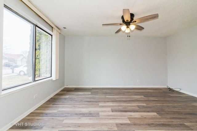 spare room with light wood-type flooring and ceiling fan