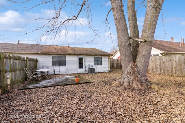 back of house with a deck and central AC