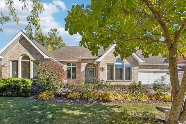 view of front of home with a garage and a front lawn