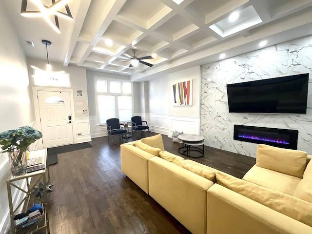 living room with ceiling fan, dark wood-type flooring, coffered ceiling, beamed ceiling, and a high end fireplace