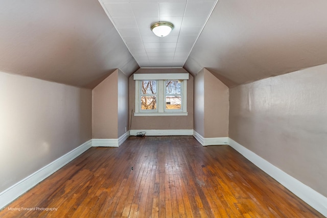 additional living space with dark hardwood / wood-style floors and vaulted ceiling