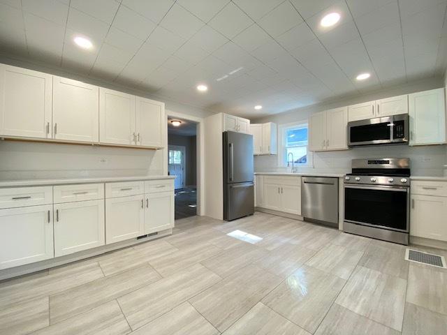 kitchen featuring sink, white cabinetry, and stainless steel appliances