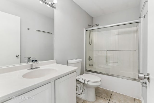 full bathroom featuring tile patterned flooring, vanity, toilet, and enclosed tub / shower combo