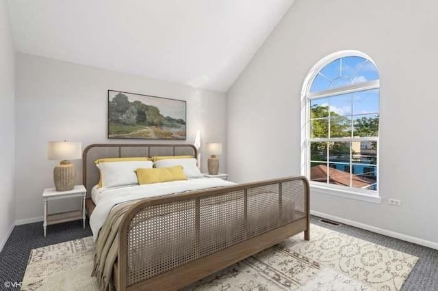 bedroom with carpet and vaulted ceiling