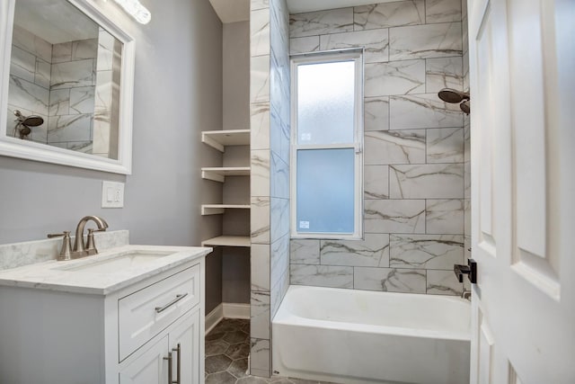 bathroom featuring vanity, tiled shower / bath combo, a healthy amount of sunlight, and tile patterned flooring