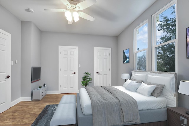 bedroom with hardwood / wood-style flooring and ceiling fan