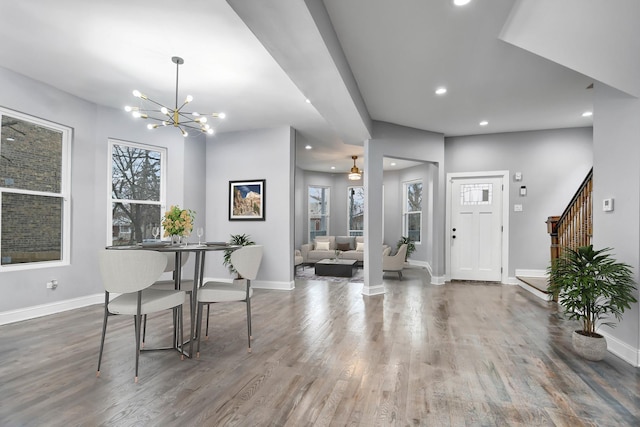 interior space with hardwood / wood-style flooring and ceiling fan with notable chandelier