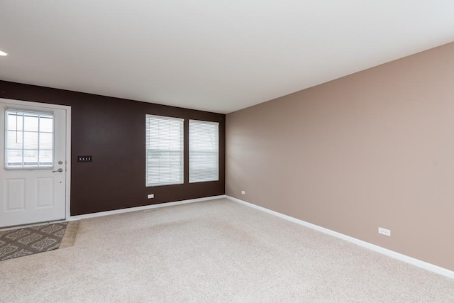 entrance foyer featuring light colored carpet