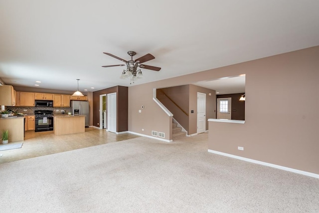 unfurnished living room featuring ceiling fan