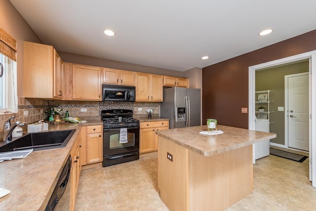 kitchen featuring light brown cabinetry, tasteful backsplash, sink, black appliances, and a center island