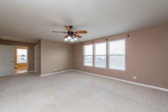 unfurnished room featuring light carpet and ceiling fan