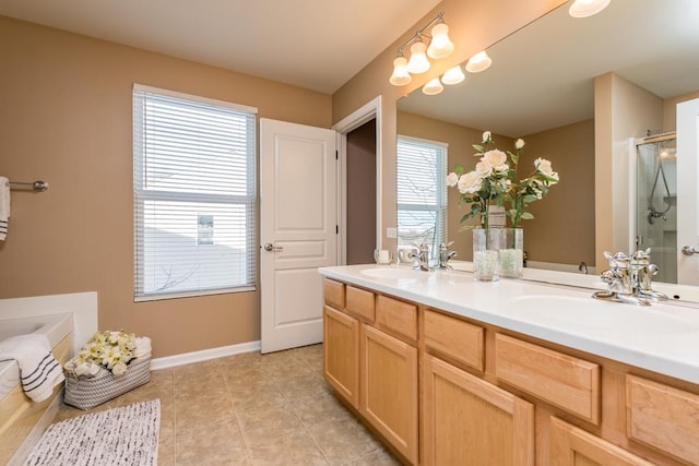 bathroom with walk in shower, vanity, a wealth of natural light, and tile patterned flooring