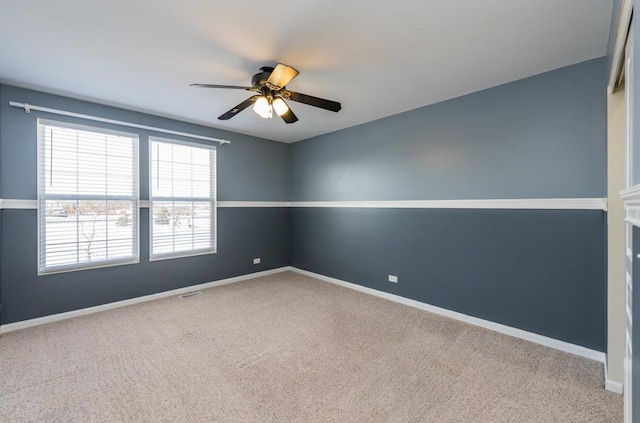 carpeted empty room featuring ceiling fan