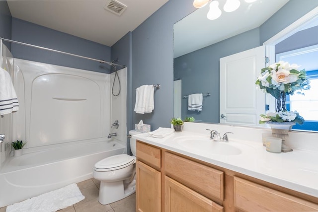 full bathroom featuring washtub / shower combination, tile patterned flooring, vanity, and toilet