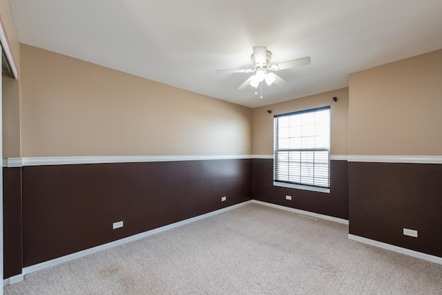 carpeted empty room with ceiling fan