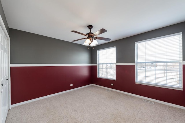 carpeted empty room with ceiling fan