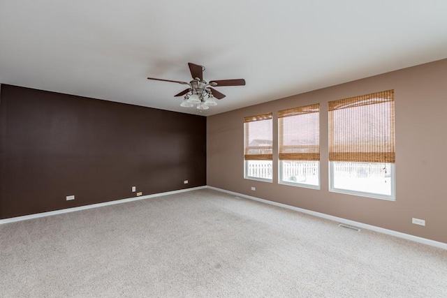 empty room with ceiling fan and carpet