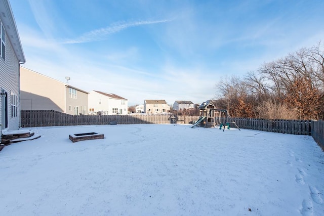 snowy yard with a playground