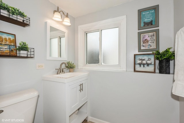 bathroom featuring vanity and toilet