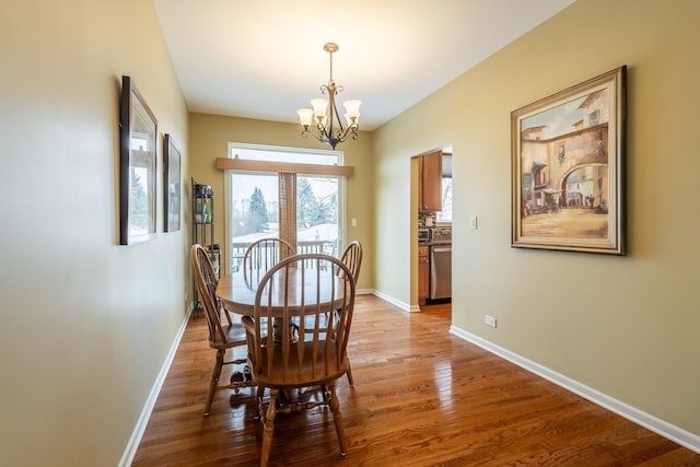 dining room with wood-type flooring and a chandelier