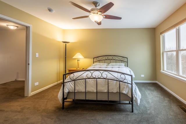 bedroom featuring ceiling fan and dark carpet