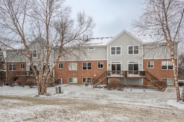 snow covered house featuring a deck