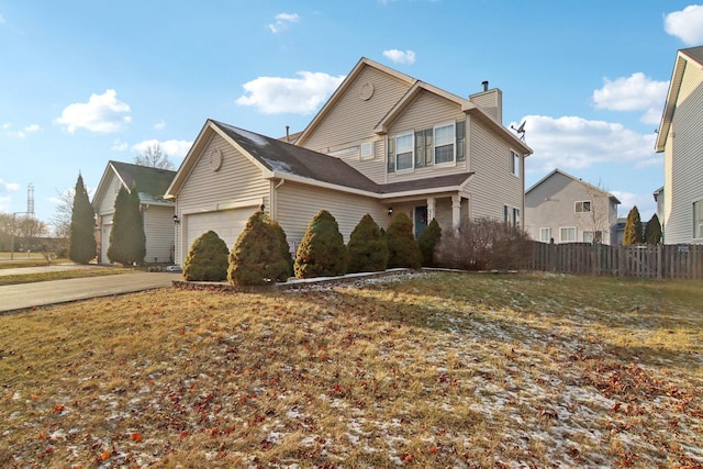 view of front of home featuring a garage and a front lawn