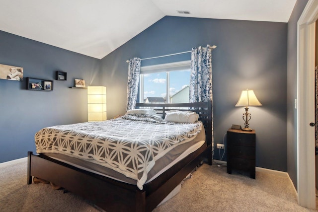 carpeted bedroom with lofted ceiling