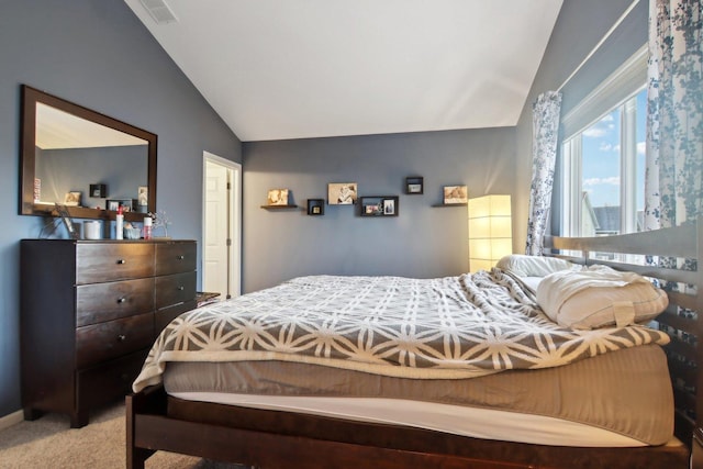 bedroom with carpet flooring and lofted ceiling