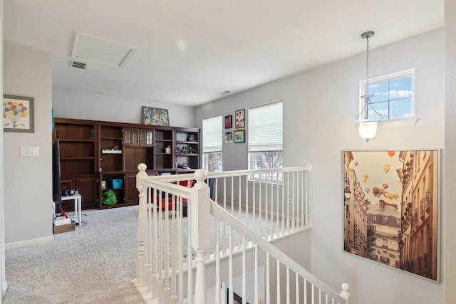 corridor featuring carpet flooring and a wealth of natural light