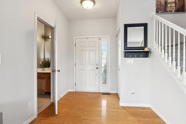 foyer entrance with light hardwood / wood-style floors