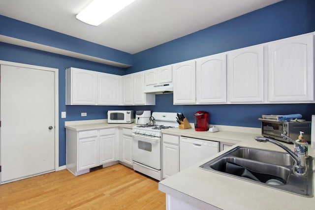 kitchen with white cabinetry, sink, white appliances, and light hardwood / wood-style flooring