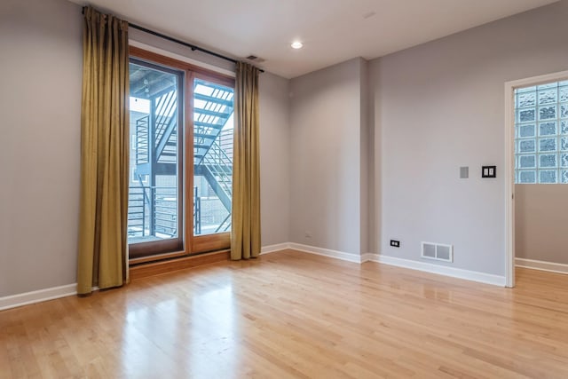 spare room with light hardwood / wood-style floors