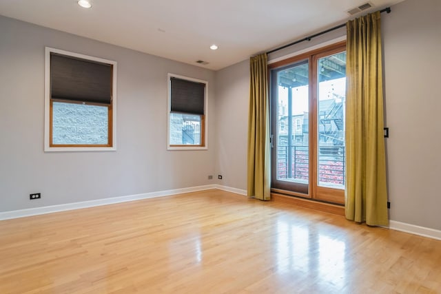 unfurnished room with light wood-type flooring