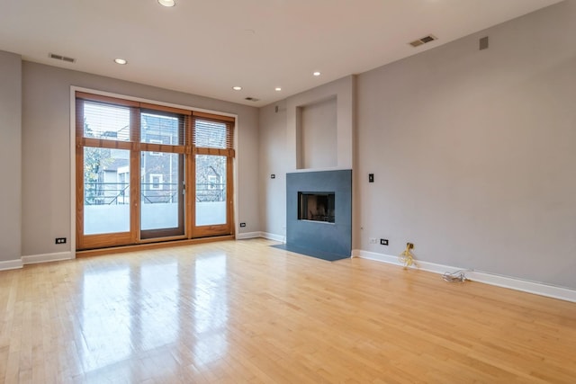 unfurnished living room with light hardwood / wood-style floors