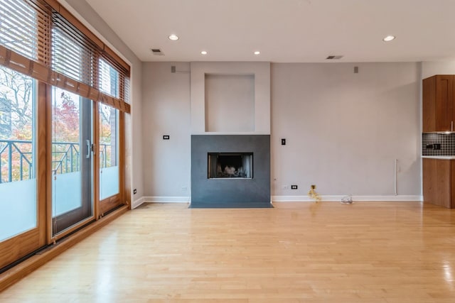 unfurnished living room with light wood-type flooring