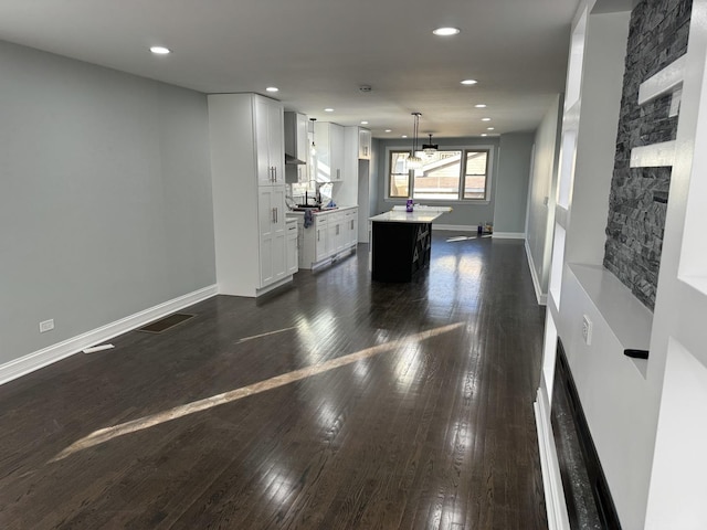 rec room featuring a fireplace and dark wood-type flooring