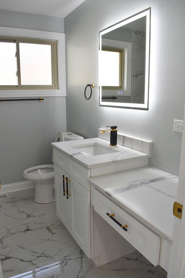 bathroom featuring vanity and toilet