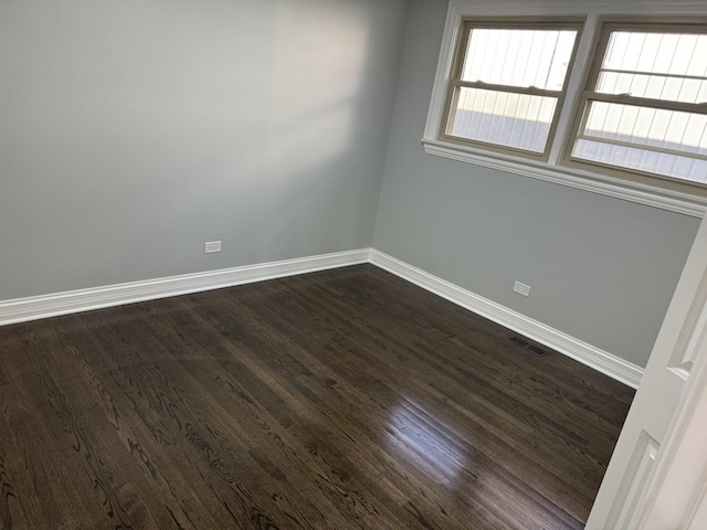 unfurnished room with dark hardwood / wood-style flooring