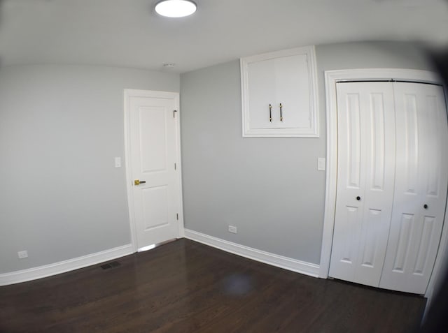 spare room with dark hardwood / wood-style flooring