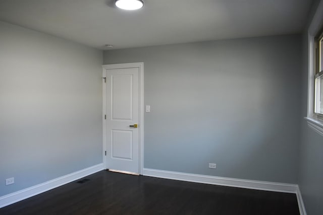 spare room with dark hardwood / wood-style flooring