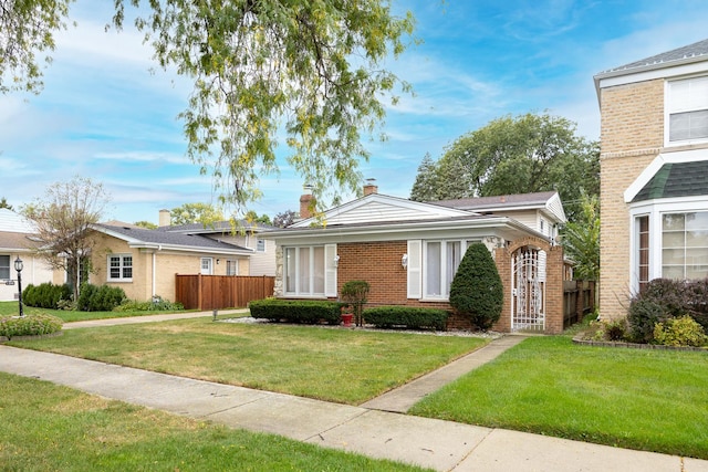 single story home featuring a front lawn