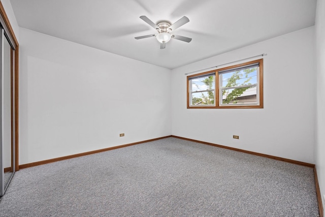 carpeted empty room with ceiling fan